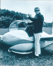 STEVE MCQUEEN POSES NEXT TO GLIDER B/W PHOTOGRAPH