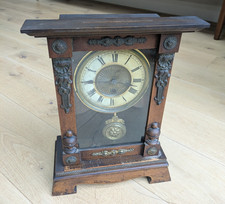 Vintage wooden ornate mantel pendulum clock with winding key