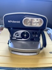 Polaroid 600 Camera. Silver Case With Navy adjustable Handle For Easy Support