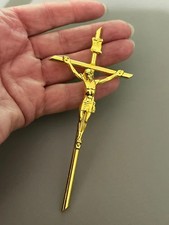 Holding devotional metal Crucifix Cross in all gold tone metal 11.5 cms