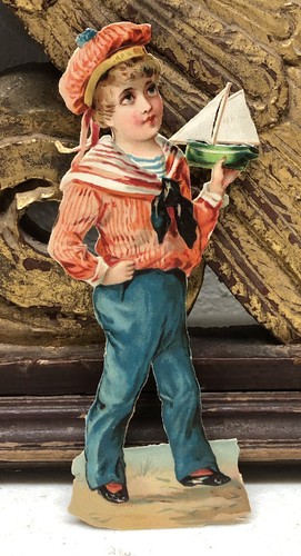 Young boy holding toy sail - holding, a