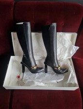 ALEXANDER MCQUEEN pointed toe leather knee high black boots with gold details 