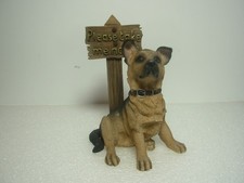 Figurine In The Form Of An German Shepherd Puppy Next To A Sign With Saying. Ron