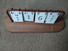 DESK FLIP OVER CALENDAR, IN GOOD WORKING ORDER. PLEASE SEE OUR PHOTOS