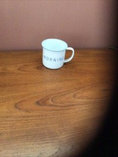 WHITE ENAMEL MUG WITH MORNING WRITTEN ON IT. NEW