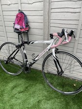 White Carrera Vanquish adult road bike with pink trim and extra accessories.