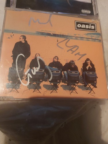 Oasis roll with signed - cd,
