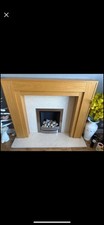 Brushed stainless steel, pebble gas fire with cream marble & oak fire surround