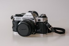 Canon AE-1 program silver c/w 50mm 1.8 lens in excellent condition.