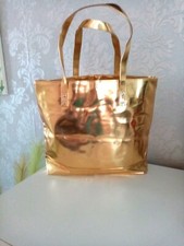 PRAI glossy gold tote bag with lotus flower print