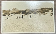 RPPC VIEW PEOPLE PLAYING ON THE BEACH & OLD LIFEBOAT HOUSE WINTERTON NORFOLK