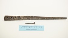 roman to medieval nail iron nail header with three tapered holes and one nail