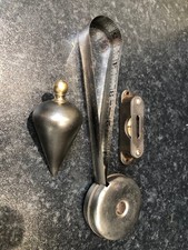 selection of small tools. spirit level, tape measur and plumb bob