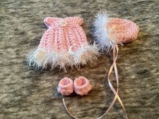 Hand knitted dolls clothes to
