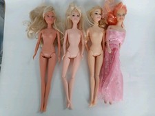 4 generic barbie sized Dolls