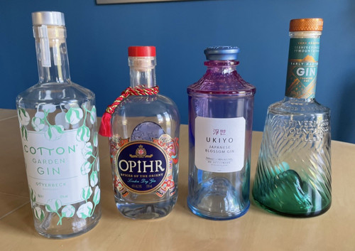 Four empty gin bottles for - empty,