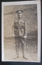 WW1 RPPC BRITISH SOLDIER 'UNCLE JOE' IN UNIFORM SWAGGER STICK UNKNOWN CAP BADGE