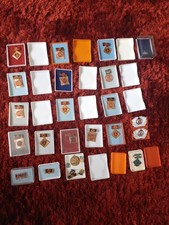 Sixteen Post War German Medals Plus Two Military Cap Badges Etcetera