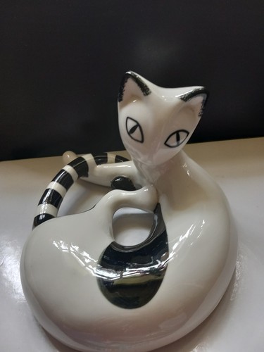 White and black cat curled - black,