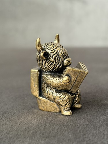 Solid brass cow reading book - brass,