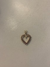 Lovely 9ct gold delicate heart shaped pendant set with red stones and a diamond