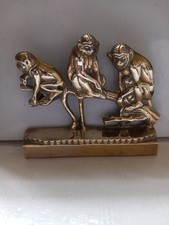 Three Brass Monkeys Sitting On