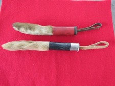 PAIR OF LUCKY RABBITS FEET MOUNTED ON CARTRIDGES WITH LEATHER THONGS