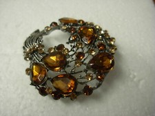 Juelz Ladies Brooch Red or Blue or Brown colours Round. Genuine Glass Crystals