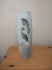 A Gebrueder Heubach small  vase decorated with fish and signed 15cms in height