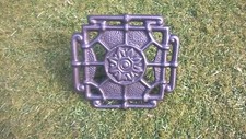 Ornate cast iron trivet for