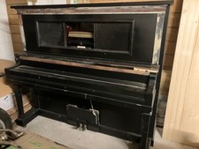 Upright piano with music rolls