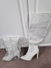 Cream over the knee boots size 7. Lined, side zip and 4 inch heel.
