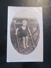 Postcard of small boy (swimming costume?) on wooden steps (Vintage)