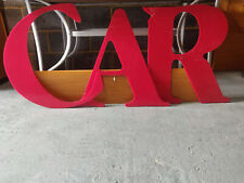 Large red perspex letters