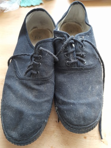 Pair worn black plimsolls - worn,