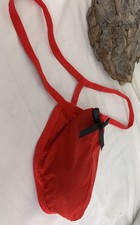 Gentleman’s Red Posing Panties with a Black Bow hand sewn on above his Frenulum 