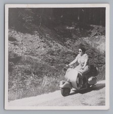 Woman on scooter Vespa 98