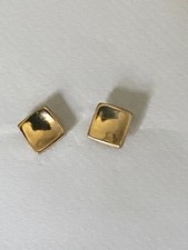 A pair of gold coloured square studs for pierced ears