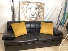 A Large Black Button Back Faux Leather Sofa in good condition