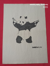 Banksy painting and drawing on