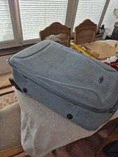 Light Blue Suitcase 2 Wheels Telescopic Handle With Some Wear On The Seams.