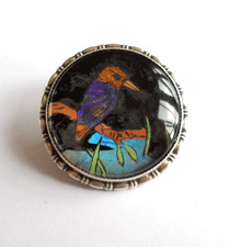 Antique circular butterfly wing silver brooch with the image of a kingfisher.