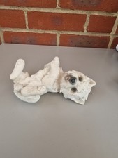 This is a figurine of a West Highland White Terrier, also known as a Westie.