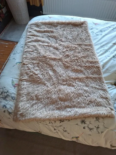 Large fluffy beige throw