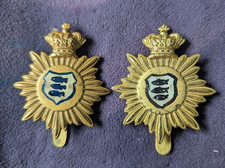 TWO BRASS CAP BADGES MADE BY