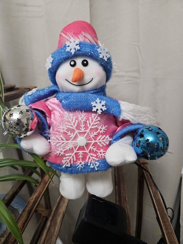 Snowman holding ornaments with - ornaments,