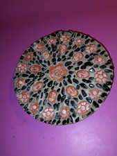 Circular Stone Decorative Paving with Faces and Flowers On Display. Stone Art