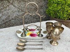 Antique silver plate egg cup holder and spoons.