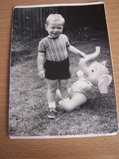 Child with Large Elephant Toy in Garden