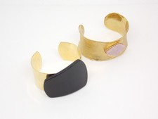 Two Gold Tone Open Bangles Including Jaeger Black Acrylic